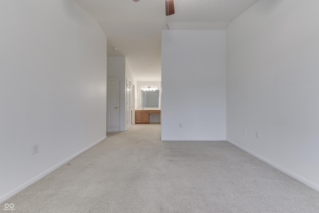 spare room with light carpet and ceiling fan