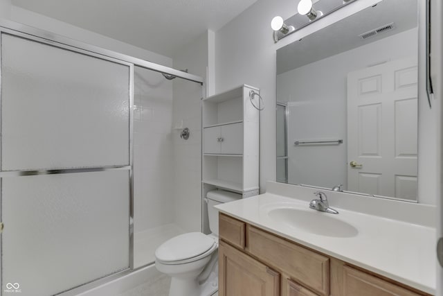 bathroom with toilet, an enclosed shower, and vanity