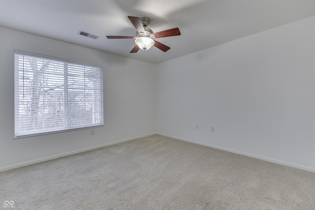 carpeted spare room with ceiling fan and a healthy amount of sunlight