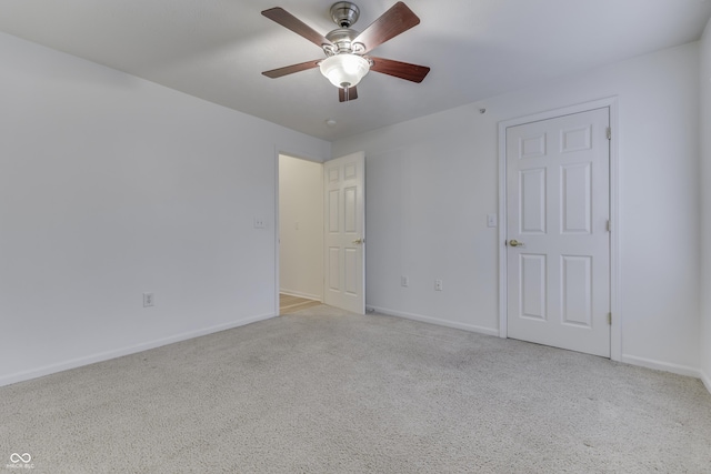 spare room featuring ceiling fan and light colored carpet