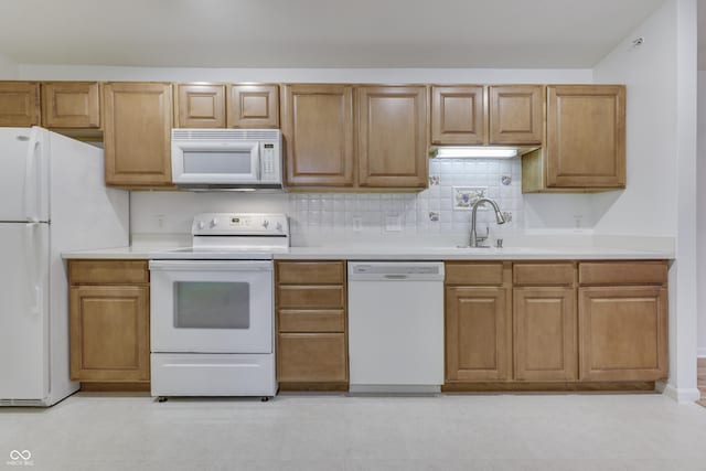 kitchen featuring tasteful backsplash, sink, and white appliances