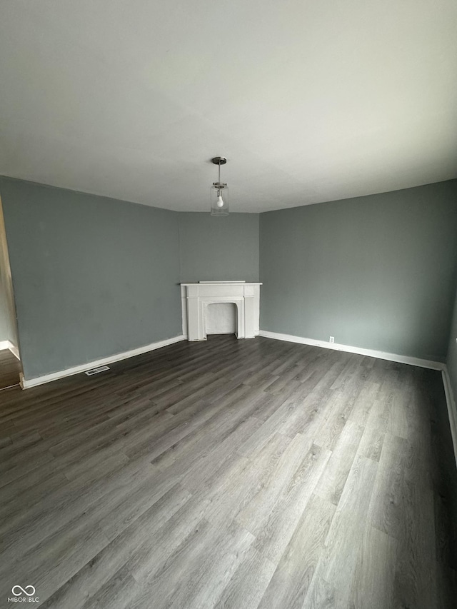 unfurnished living room featuring a fireplace and hardwood / wood-style floors