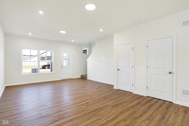 unfurnished living room with dark wood-type flooring