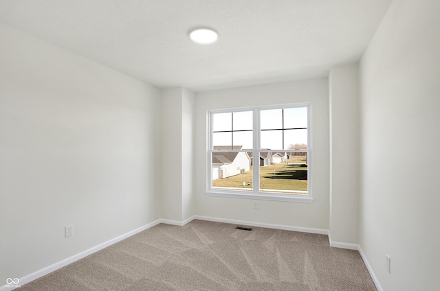 empty room featuring light colored carpet