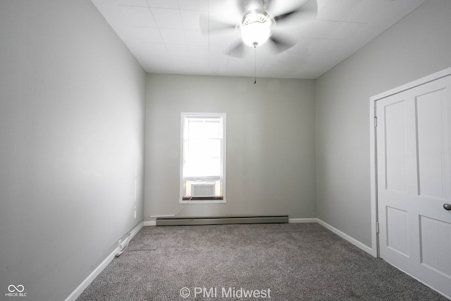 carpeted spare room featuring ceiling fan and a baseboard heating unit