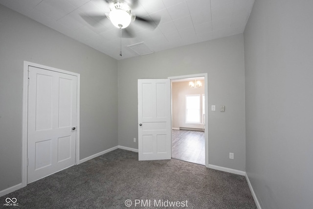 unfurnished bedroom with dark colored carpet and ceiling fan