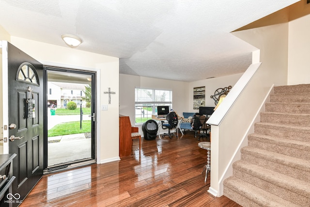 entrance foyer featuring a textured ceiling and hardwood / wood-style flooring