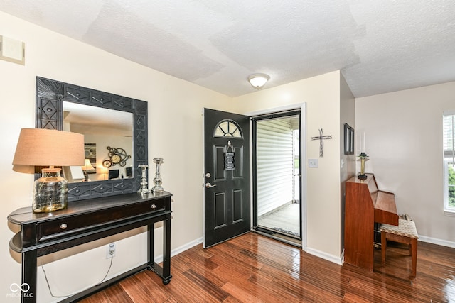 entrance foyer with wood-type flooring and a textured ceiling