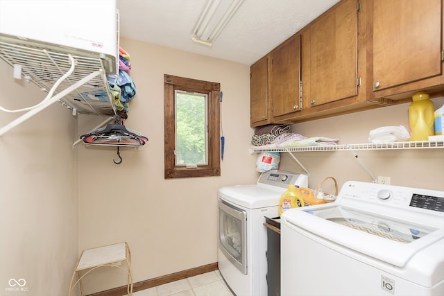 washroom featuring cabinets and washing machine and dryer