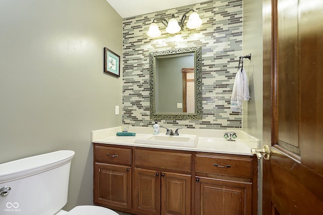 bathroom with tasteful backsplash, vanity, and toilet