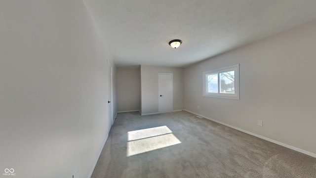 unfurnished room with light colored carpet