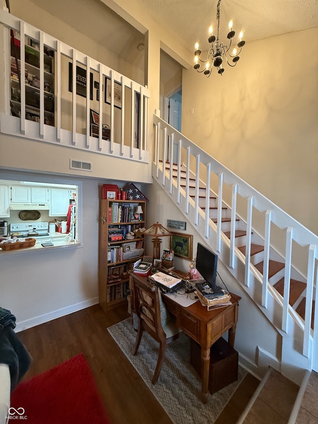 dining area with hardwood / wood-style flooring, a notable chandelier, a textured ceiling, and vaulted ceiling