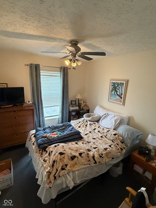 carpeted bedroom with ceiling fan and a textured ceiling