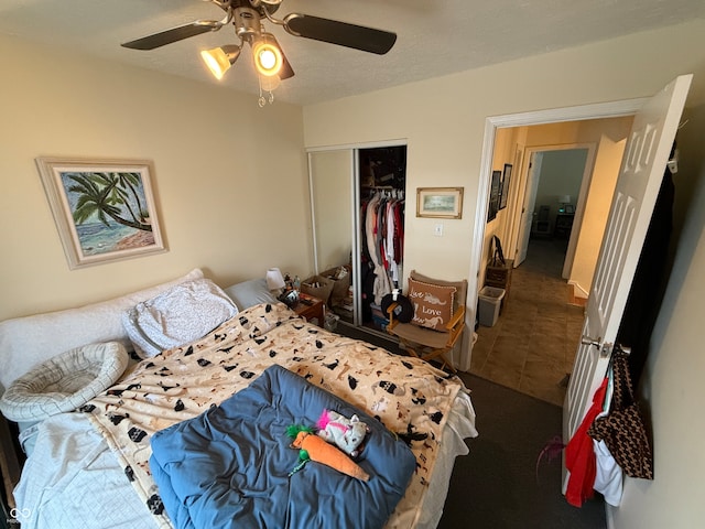 tiled bedroom with a textured ceiling, a closet, and ceiling fan