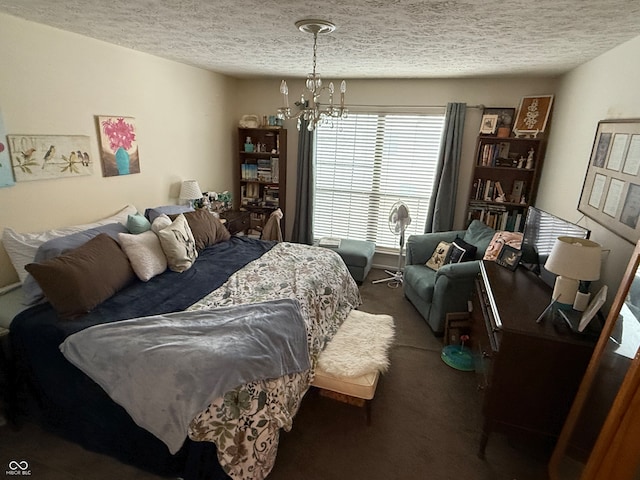 carpeted bedroom featuring a notable chandelier and a textured ceiling