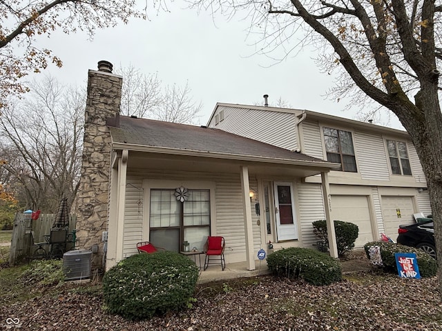 view of front of home featuring central AC unit and a garage