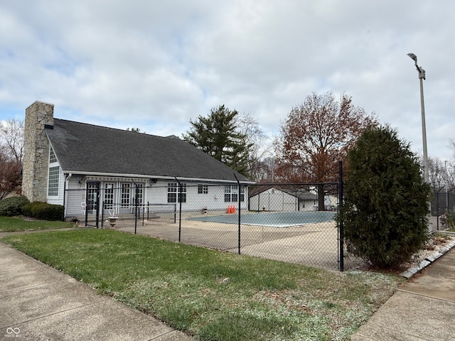 exterior space with a lawn and tennis court