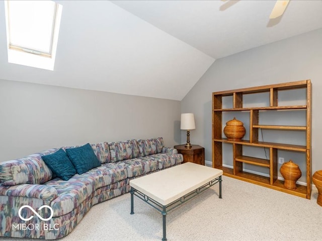 living room with ceiling fan, vaulted ceiling with skylight, and carpet floors