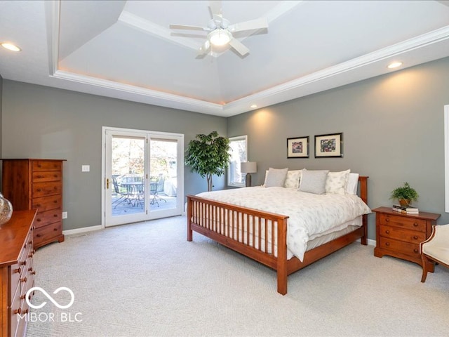 carpeted bedroom featuring access to outside, a raised ceiling, and ceiling fan