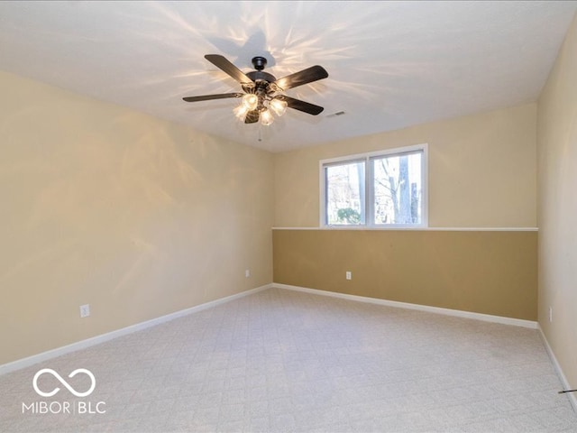 unfurnished room featuring light carpet and ceiling fan