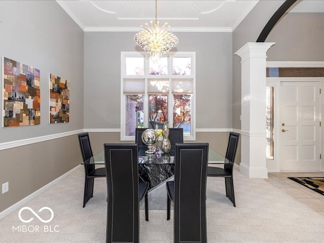 dining area featuring decorative columns, light carpet, a chandelier, and ornamental molding