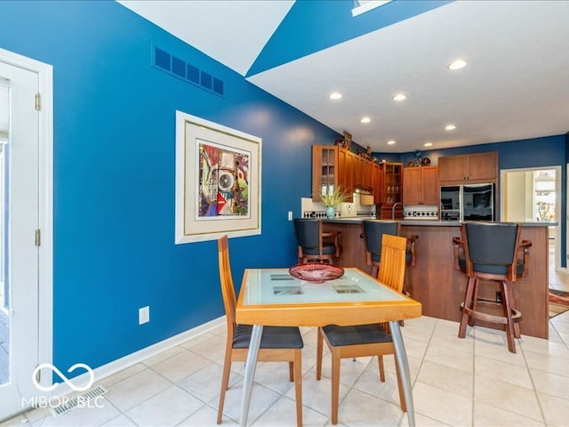 dining room with sink and light tile patterned flooring