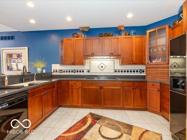 kitchen featuring sink, black dishwasher, cooktop, decorative backsplash, and light tile patterned floors