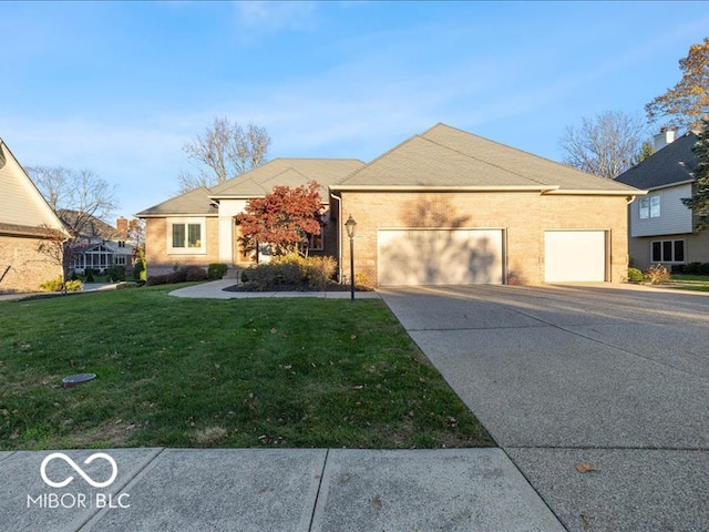 view of front of home with a garage and a front lawn