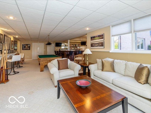 12954 Water Ridge Dr, Fishers, IN 46055 - living room with billiards, light colored carpet, a dry bar, and recessed lighting
