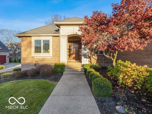 12954 Water Ridge Dr, Fishers, IN 46055 - doorway to property featuring brick siding and roof with shingles