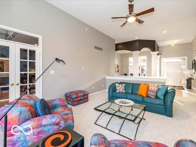 carpeted living room featuring french doors and ceiling fan