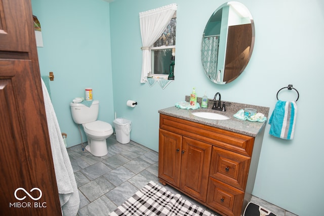 bathroom featuring vanity and toilet