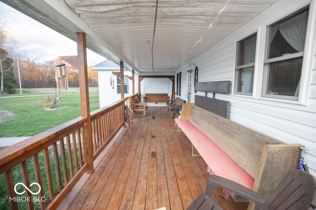 deck featuring a yard and a porch