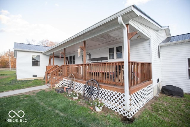 6255 E County Road 850 N, North Vernon, IN 47265 - view of front of house featuring a metal roof, a front lawn, and covered porch