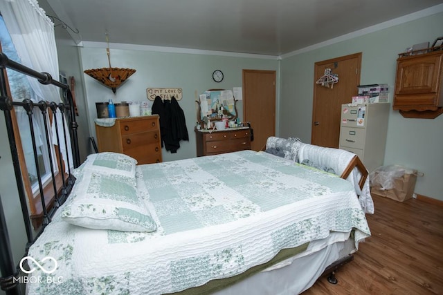6255 E County Road 850 N, North Vernon, IN 47265 - bedroom with wood finished floors, crown molding, and freestanding refrigerator