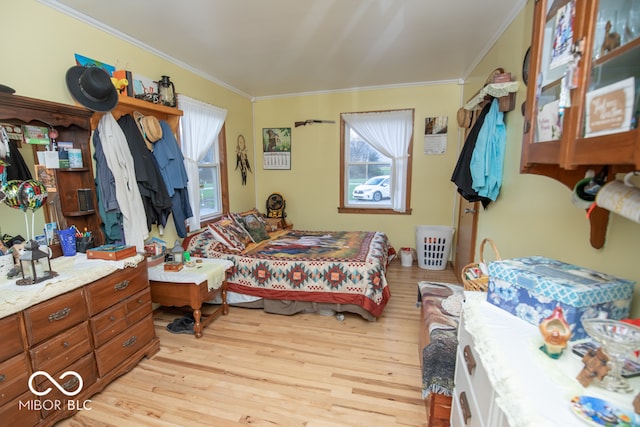 bedroom with ornamental molding and light wood-type flooring