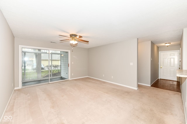 carpeted empty room with ceiling fan