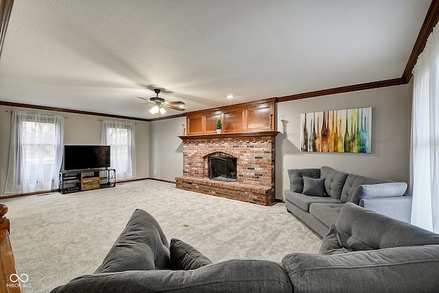 living room featuring ornamental molding, a textured ceiling, ceiling fan, a fireplace, and carpet floors