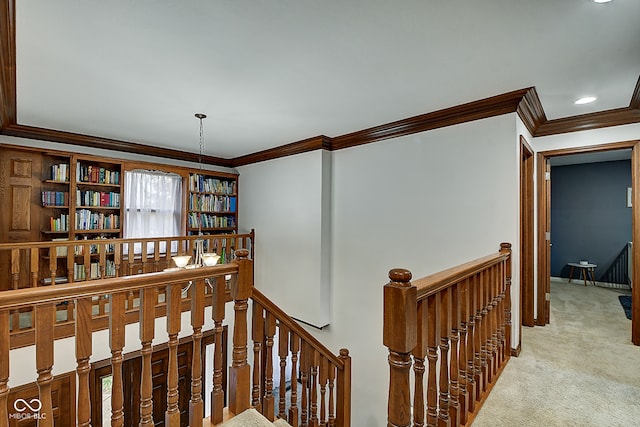 stairs with carpet, ornamental molding, and an inviting chandelier