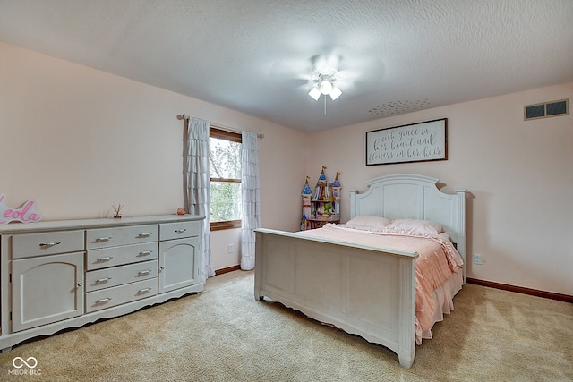 bedroom with light carpet, a textured ceiling, and ceiling fan