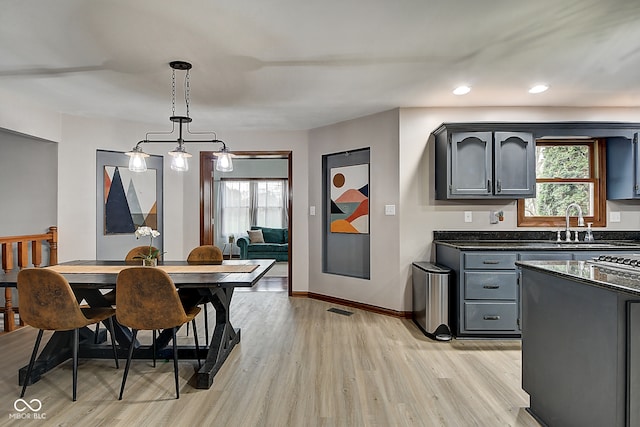 dining room featuring sink and light wood-type flooring