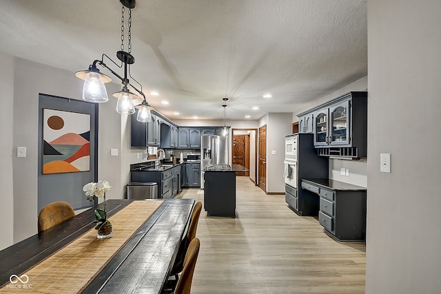 dining area featuring sink and light hardwood / wood-style floors