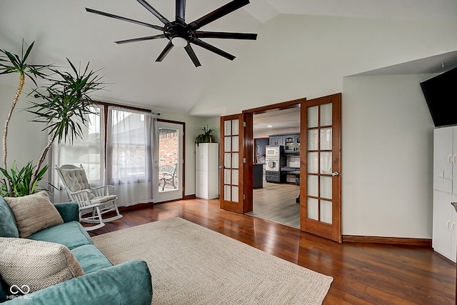 living room with dark hardwood / wood-style floors, ceiling fan, vaulted ceiling, and french doors