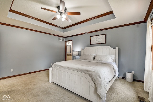 bedroom featuring a raised ceiling, ceiling fan, light carpet, and ornamental molding