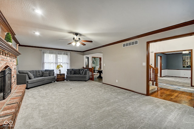 unfurnished living room featuring hardwood / wood-style flooring, ceiling fan, a textured ceiling, and ornamental molding