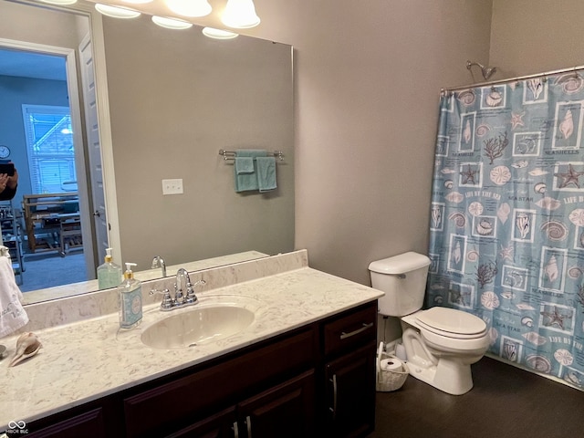 bathroom with vanity, toilet, and a shower with curtain