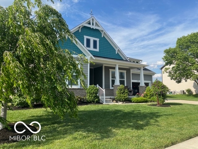 view of front of property with a porch and a front yard