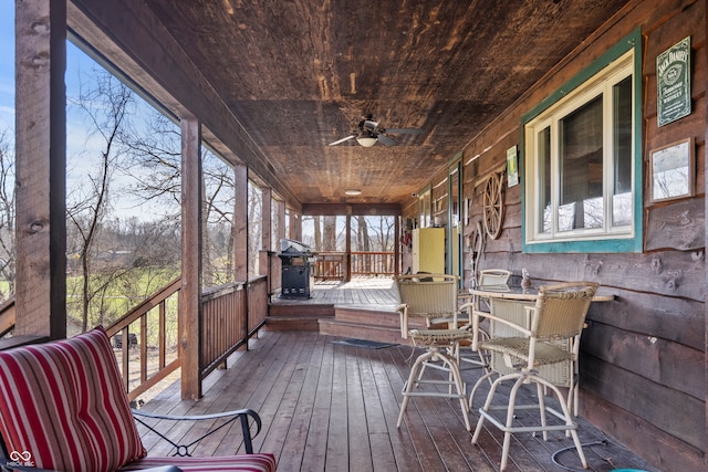 sunroom / solarium with wooden ceiling and a ceiling fan