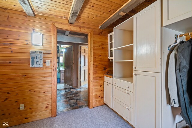 spacious closet with beam ceiling and carpet flooring