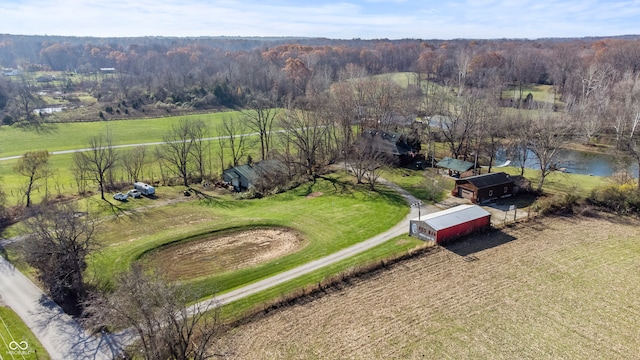 birds eye view of property featuring a rural view and a view of trees